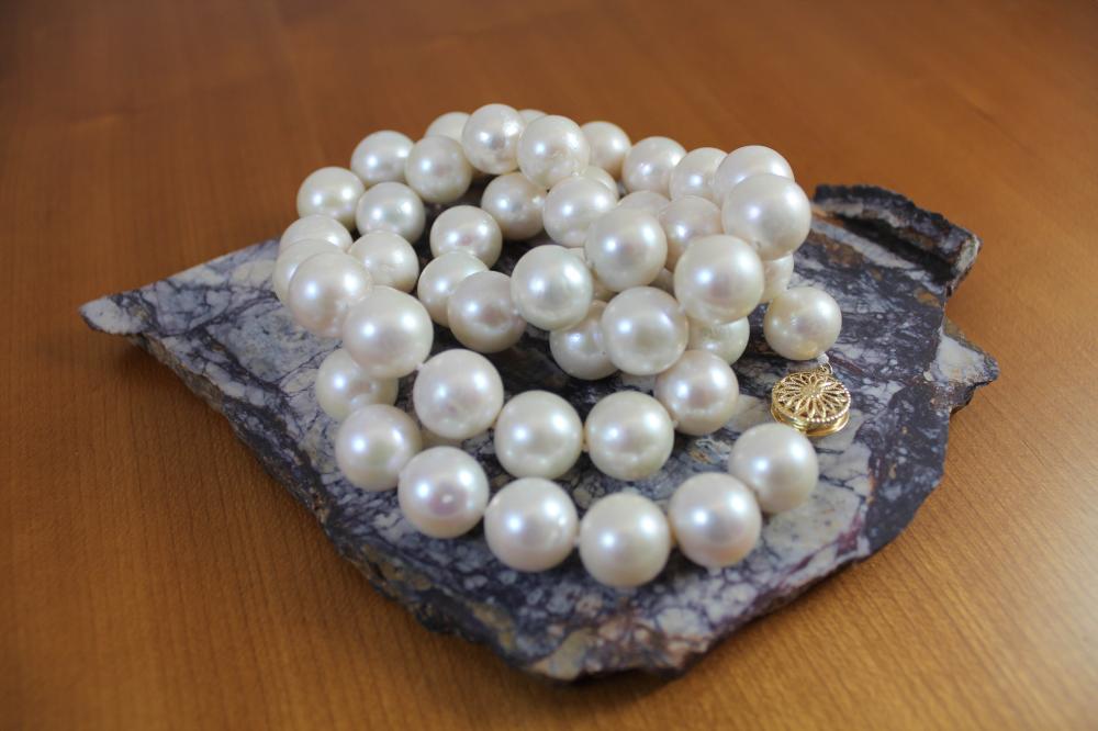 Appraisal: OPERA LENGTH PEARL AND EIGHTEEN KARAT GOLD NECKLACE hand-knotted strand