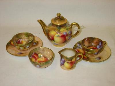 Appraisal: A ROYAL WORCESTER PORCELAIN MINIATURE TEA SET comprising teapot milk