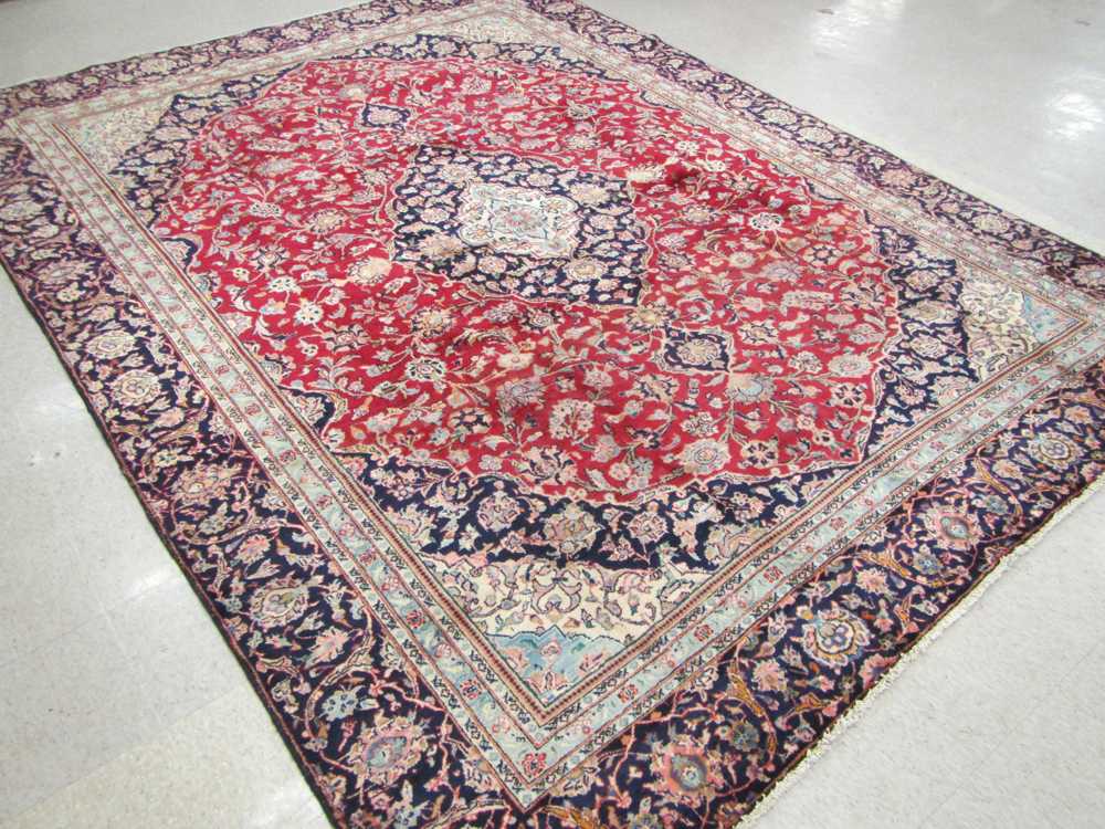 Appraisal: HAND KNOTTED PERSIAN CARPET floral and central floral medallion design