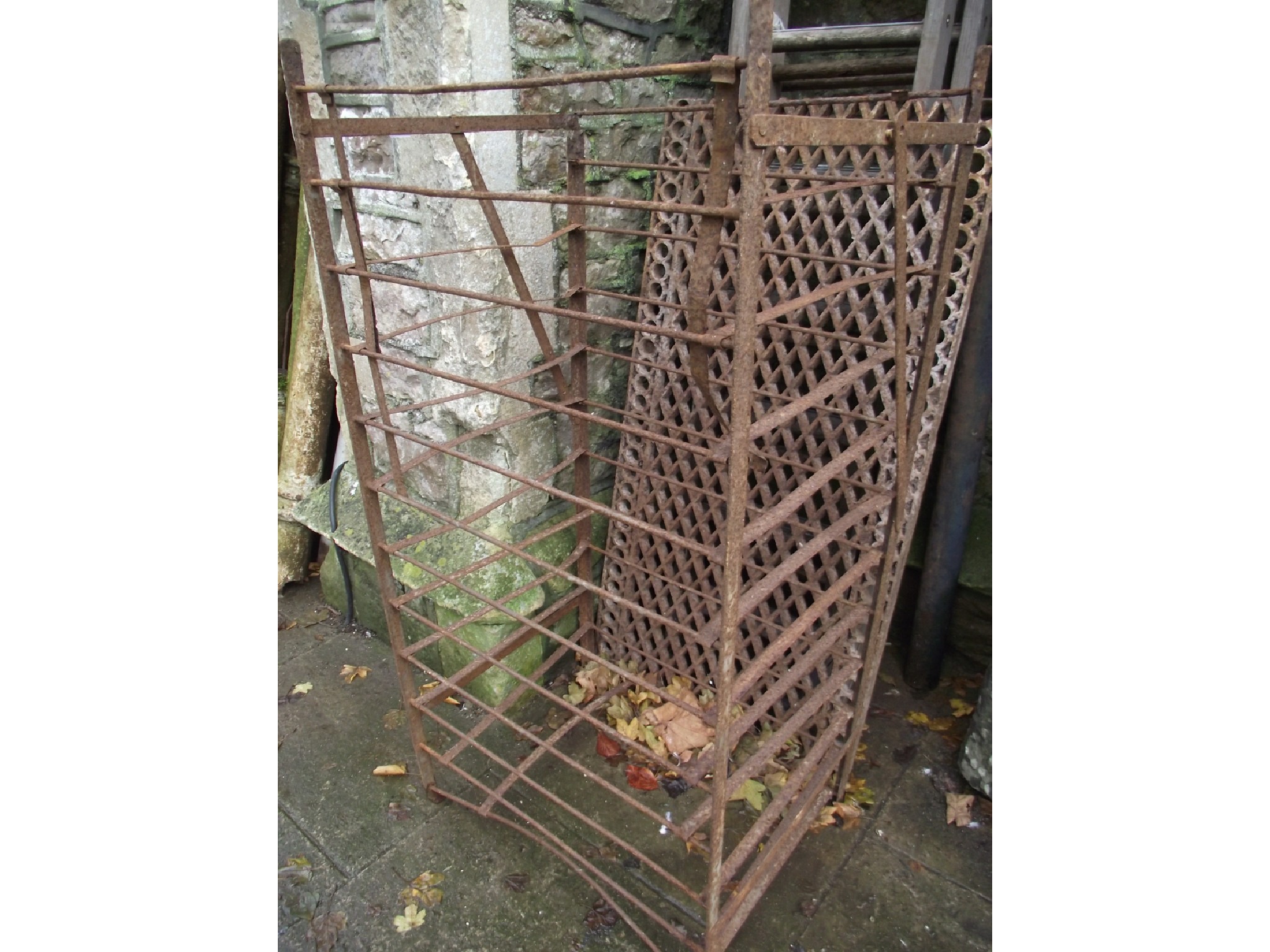 Appraisal: A vintage floorstanding steel fruit rack stand together with a