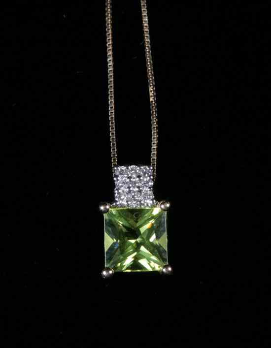 Appraisal: K YELLOW GOLD PERIDOT AND DIAMOND PENDANT Scissors-cut square peridot