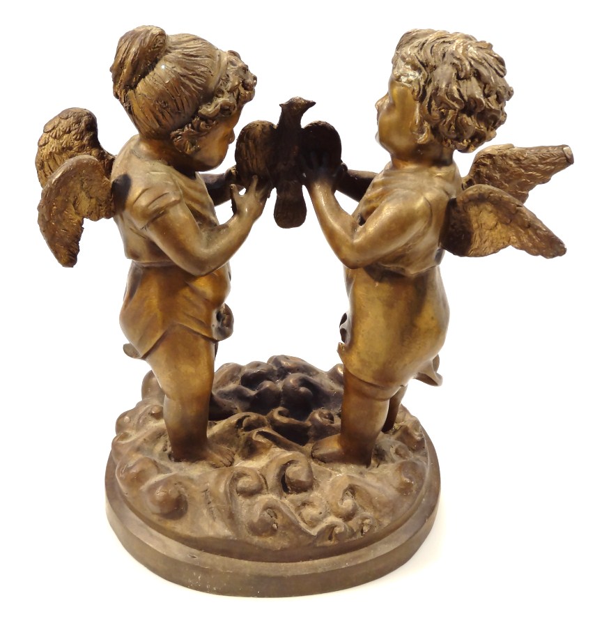 Appraisal: A thC bronzed classical figure group of two cherubs standing