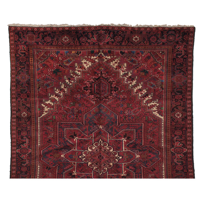 Appraisal: Persian Heriz rug c stylized floral design on a red