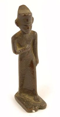 Appraisal: An Egyptian bronze figure wearing a headdress and walking in