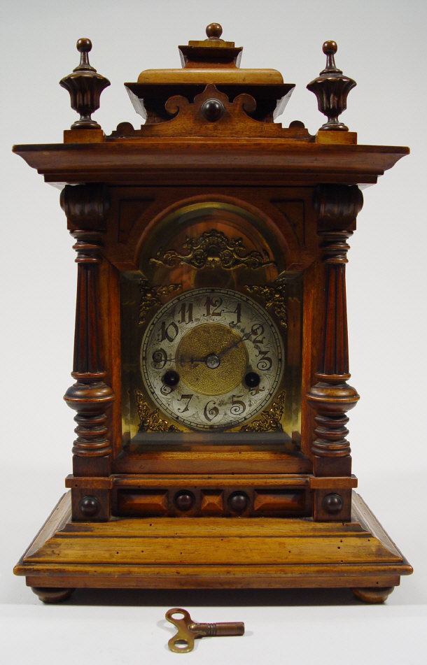 Appraisal: Walnut cased chiming mantel clock with brass dial and German