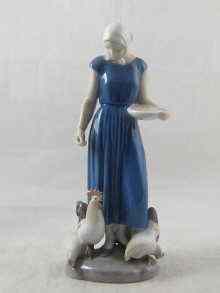 Appraisal: A Royal Copenhagen model of a girl feeding hens cm