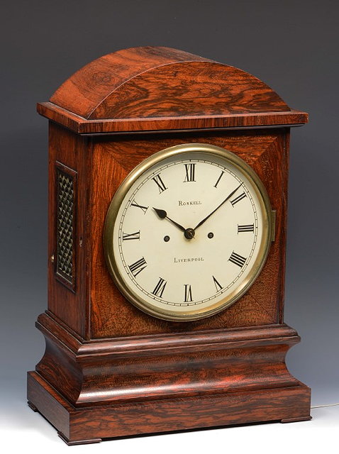 Appraisal: A VICTORIAN ROSEWOOD BRACKET OR TABLE CLOCK the circular white