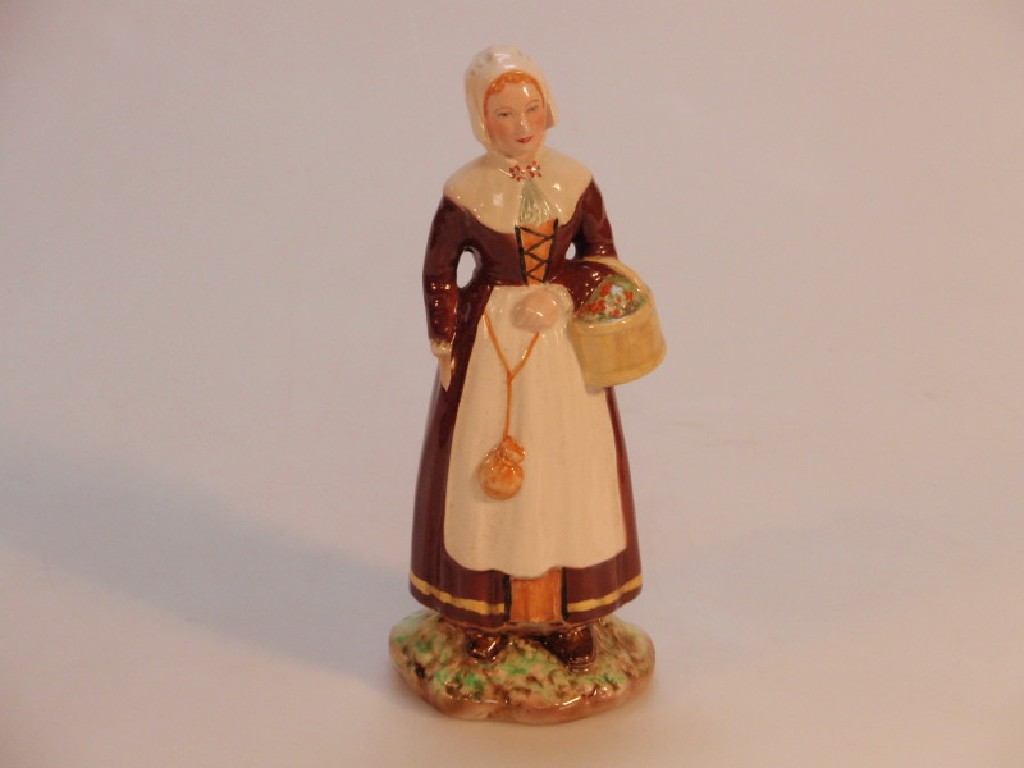 Appraisal: A Falconware pottery model of a waiting woman holding a