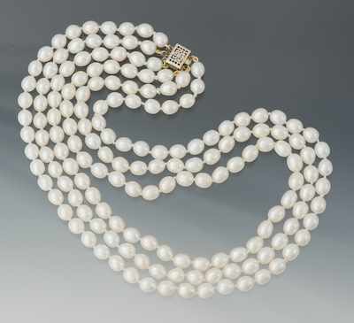 Appraisal: A Triple Strand Pearl Necklace Individually strung freshwater cultured oval