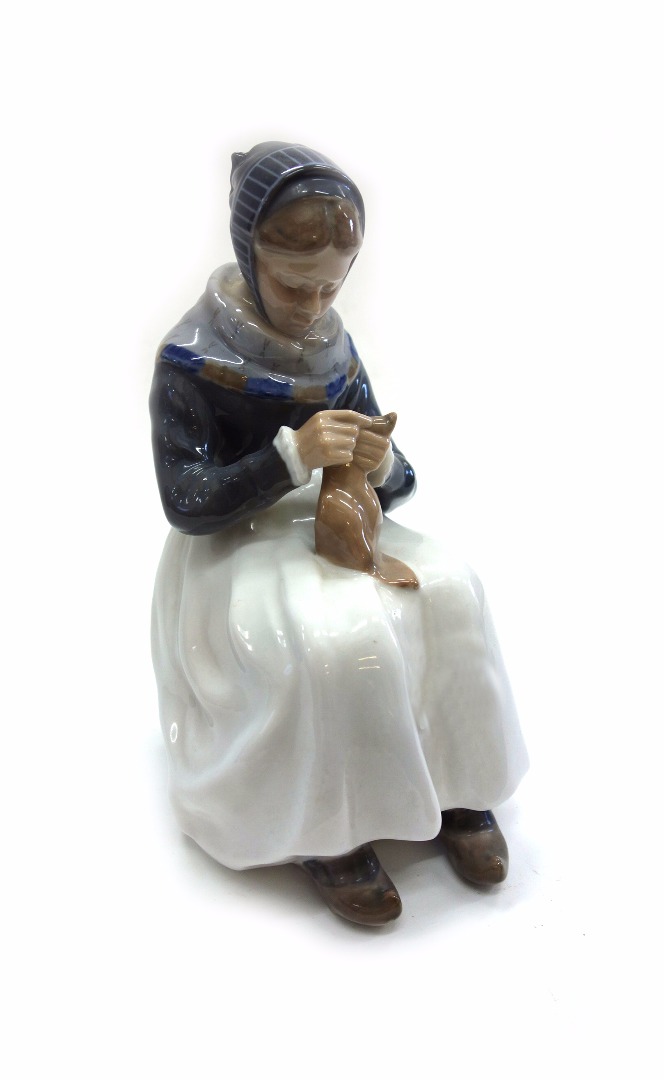 Appraisal: A Royal Copenhagen porcelain figure of a woman knitting model