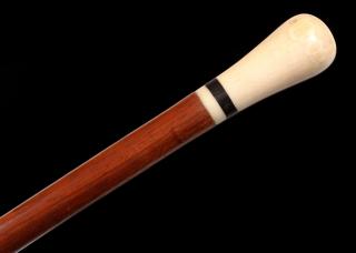 Appraisal: A THC WALKING STICK WITH IVORY KNOB HANDLE The mahogany