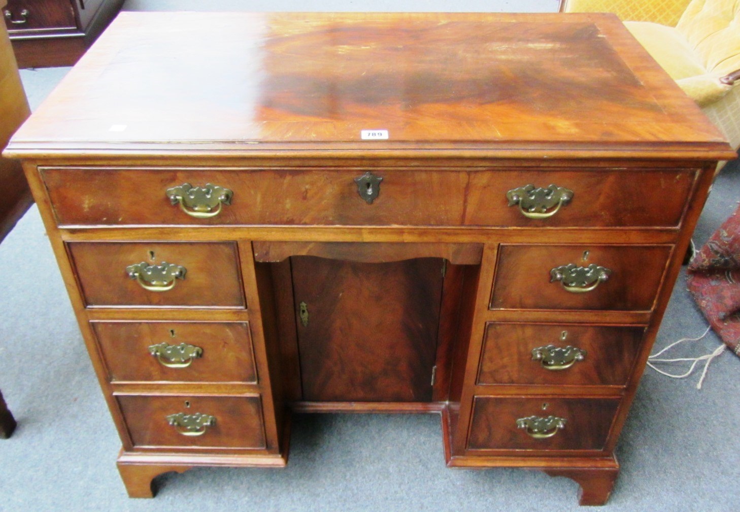 Appraisal: A th century mahogany kneehole writing desk with seven drawers