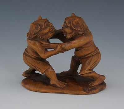 Appraisal: Two Wrestling Oni in Carved Wood Signed Tomokazu th Century