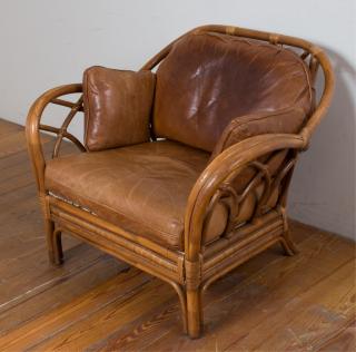 Appraisal: Benchcraft Rattan Armchair Benchcraft rattan armchair with leather cushions measures