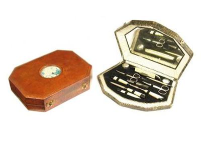 Appraisal: A faux crocodile cased manicure set with a inset mirrored