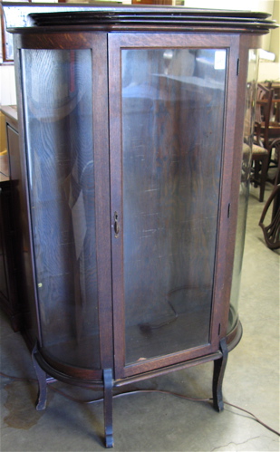 Appraisal: DARK OAK AND CURVED GLASS CHINA CABINET American c with