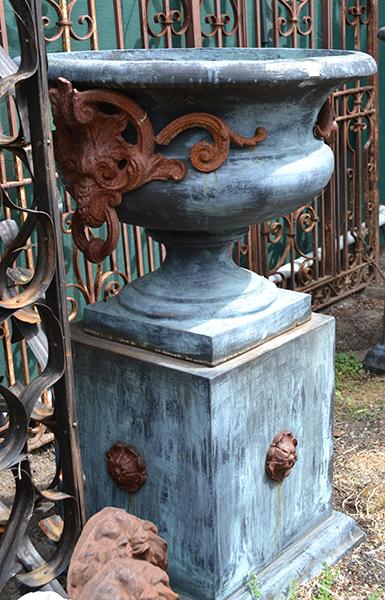 Appraisal: A PAIR OF GREEN PATINATED COMPOSITE URNS ON STANDSeach with