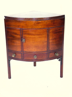 Appraisal: A mahogany bowfront corner cabinet late th century the reed