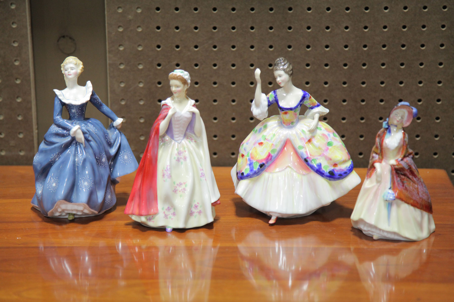 Appraisal: FOUR ROYAL DOULTON FIGURES English th century Bess HN ''h