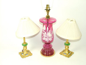 Appraisal: A brass mounted cranberry glass table lamp painted with flowers