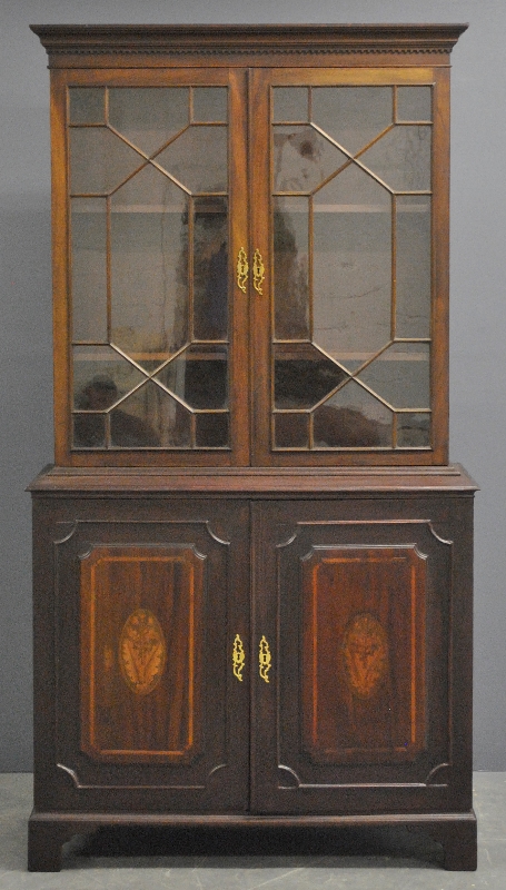 Appraisal: - George III two-piece mahogany cabinet with a dental molded