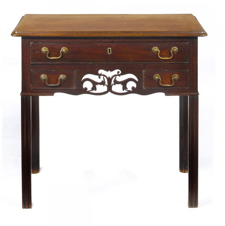 Appraisal: A GEORGE III MAHOGANY LOWBOY with three drawers and fretted