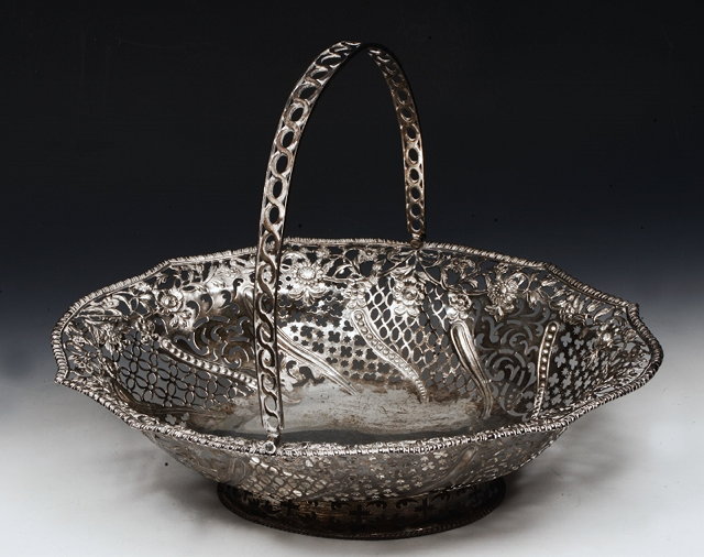 Appraisal: A GEORGE III SILVER BASKET with pierced and chased scroll