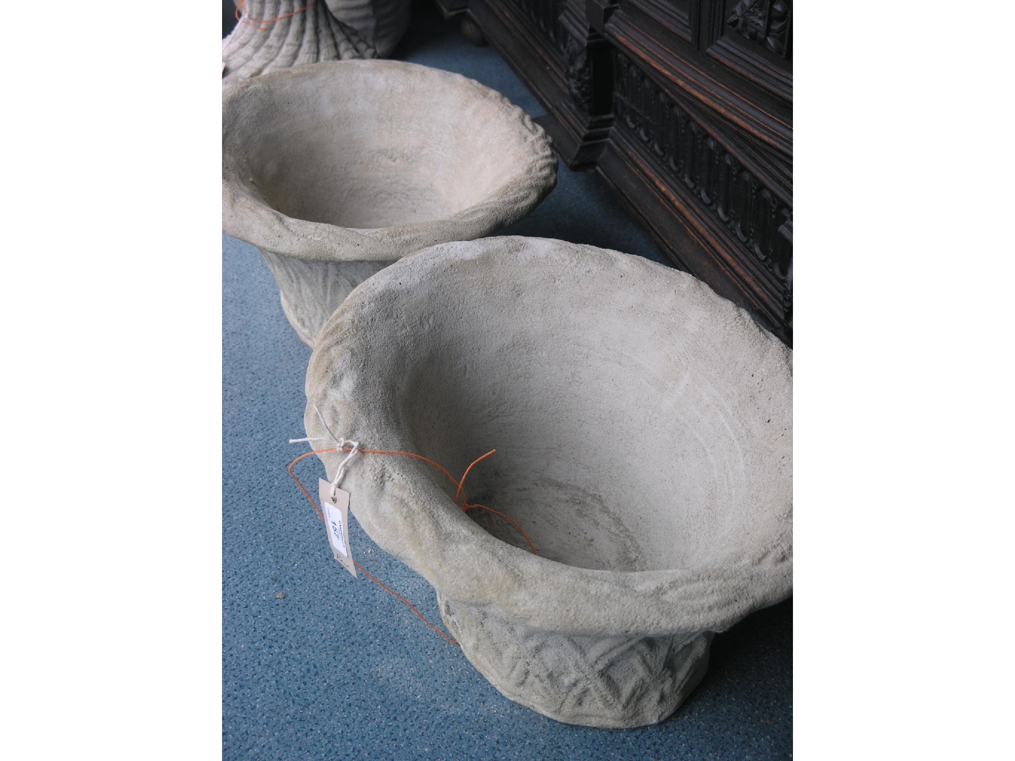 Appraisal: A pair of moulded concrete oval planters wicker-effect