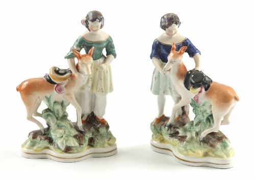 Appraisal: A pair of th century Staffordshire figures of girls with