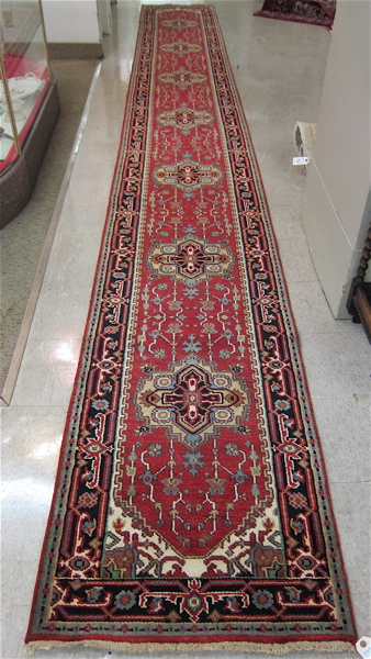 Appraisal: HAND KNOTTED ORIENTAL RUNNER Indo-Persian seven cruciform medallion design and