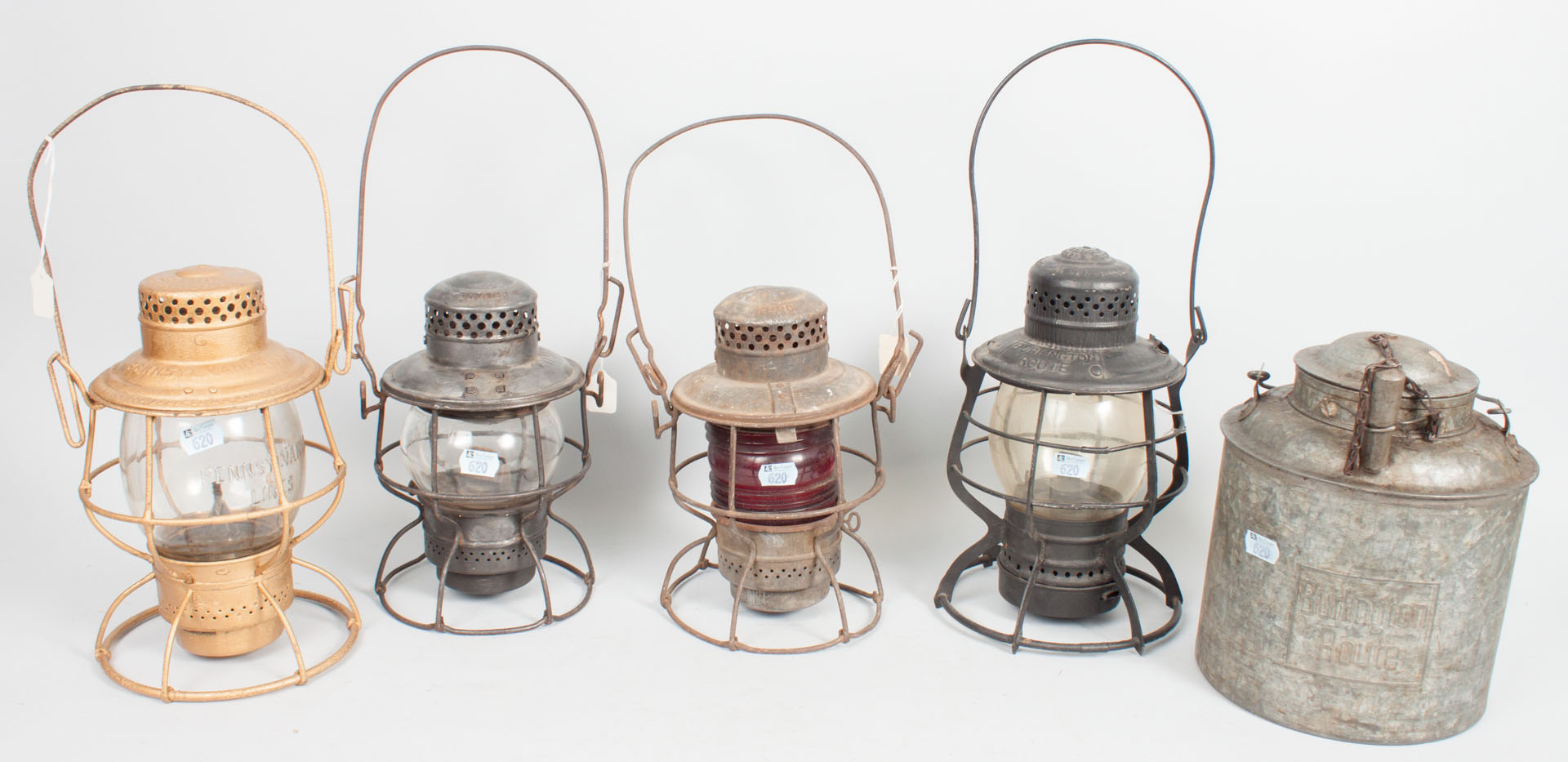 Appraisal: Four railroad lanterns and an oil can metal lanterns with