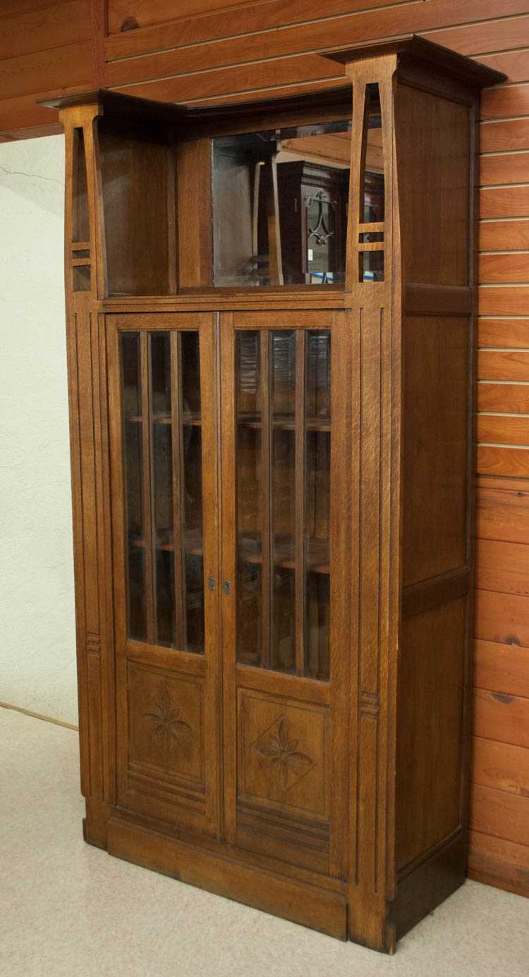 Appraisal: AN OAK CABINET BOOKCASE Continental c a double-door bookcase with