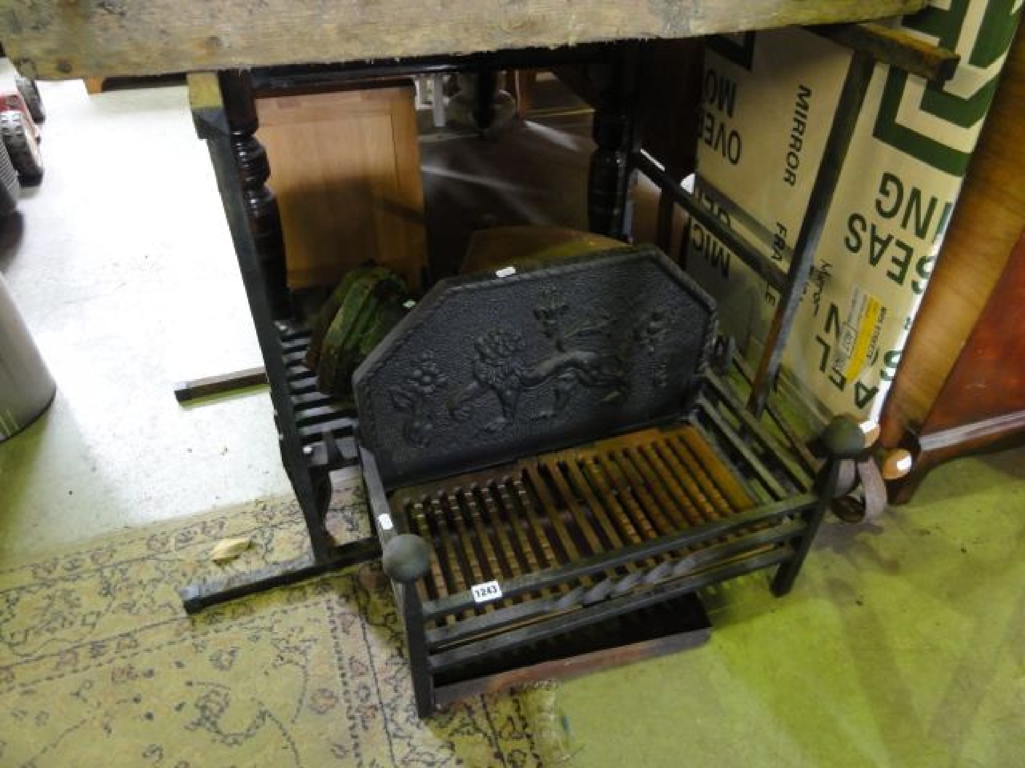 Appraisal: A cast iron fire basket and back with rampant lion