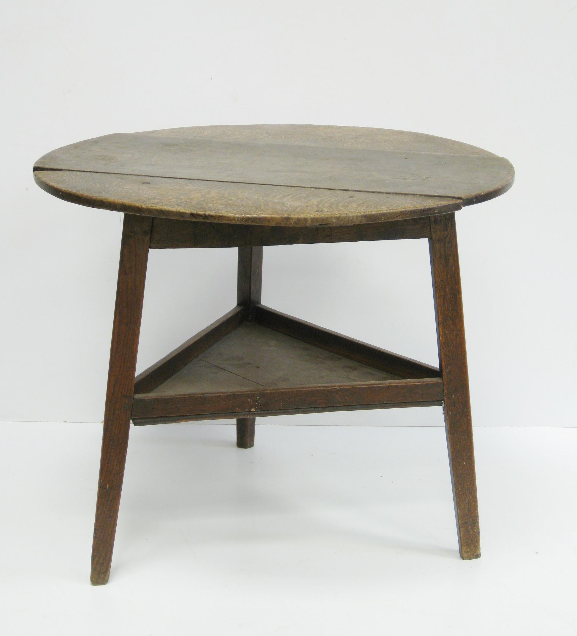 Appraisal: An antique oak Cricket Table with circular top and triangular