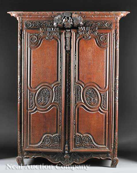 Appraisal: A French Provincial Highly Carved Oak Armoire de Mariage stepped