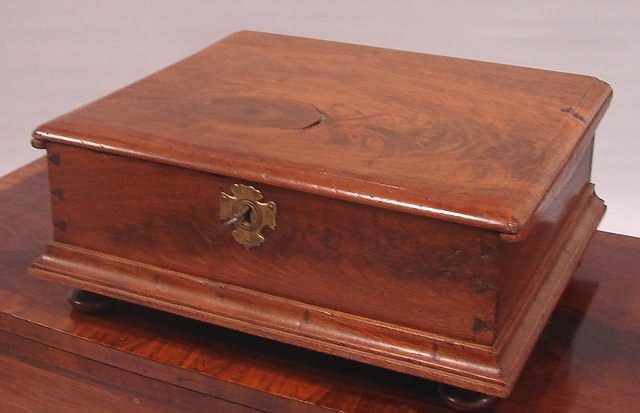 Appraisal: Walnut dove tailed case with hinged lid turned feet t