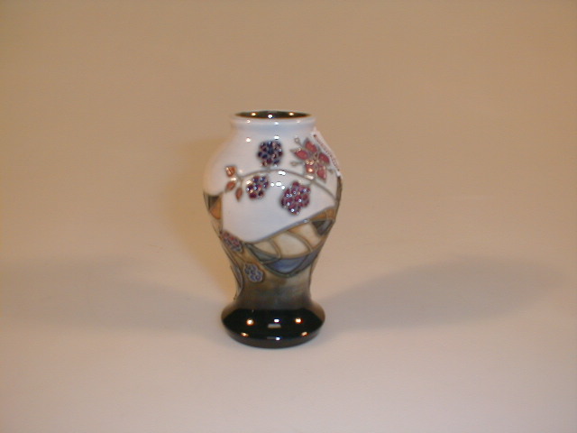 Appraisal: A small modern Moorcroft vase with blackberry decoration