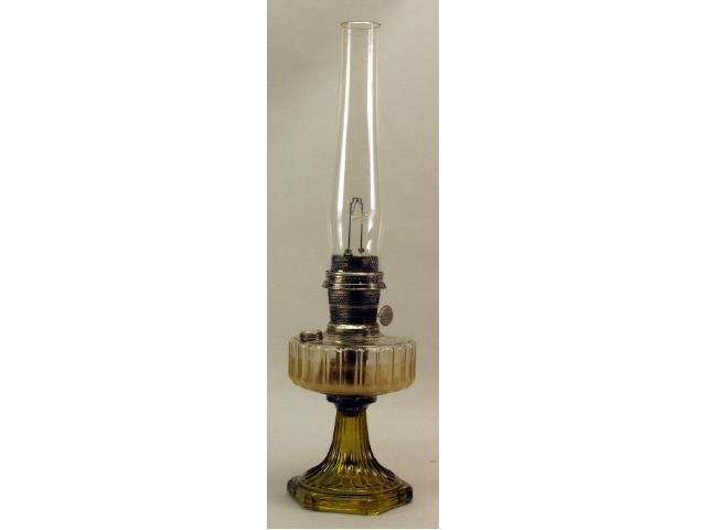 Appraisal: Footed amber and clear glass Aladdin kerosene lamp with the