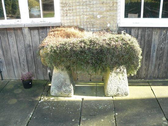 Appraisal: A rectangular stone trough raised on staddle stone tapered supports