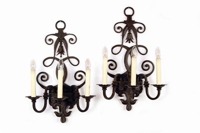 Appraisal: A set of four wrought iron wall lights by Chelsom