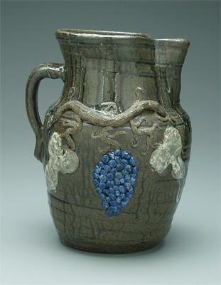 Appraisal: Decorated Hewell stoneware pitcher applied grapes and vine runny alkaline