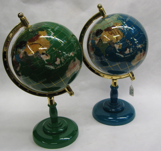 Appraisal: PAIR OF REVOLVING WORLD GLOBES with table pedestal bases gold