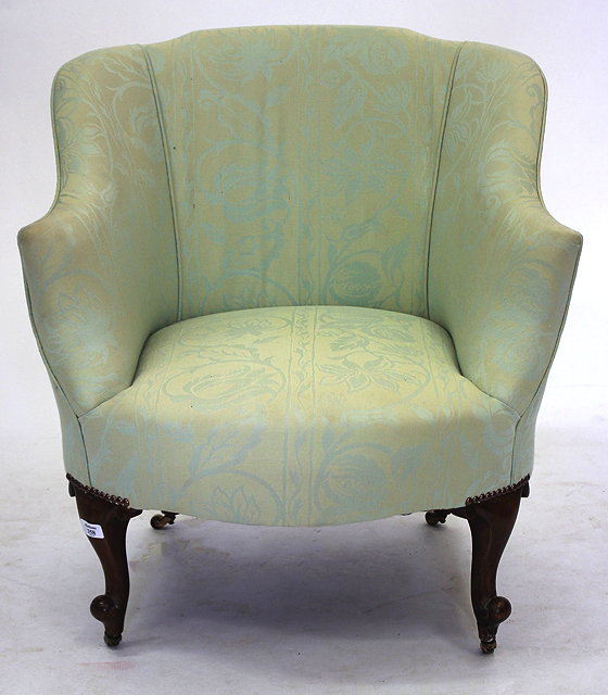 Appraisal: AN EDWARDIAN UPHOLSTERED TUB CHAIR with mahogany cabriole legs and