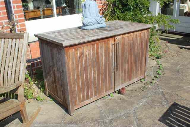 Appraisal: A TEAK TWO DOOR GARDEN CUPBOARD wide x high complete