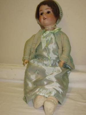 Appraisal: A Schoenau Hoffmeister bisque head girl doll with brown glass