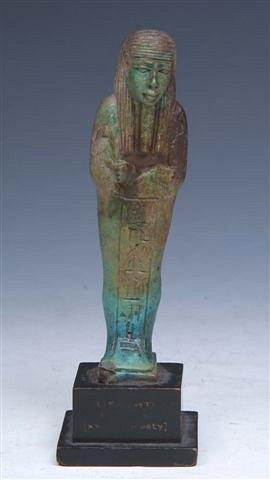 Appraisal: AN EGYPTIAN USHABTI OR FUNERARY FIGURE with turquoise glaze on