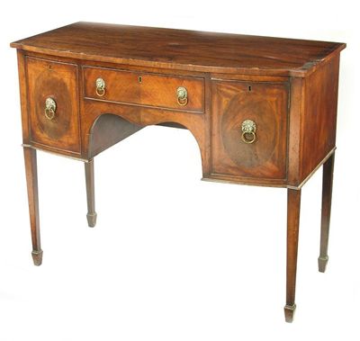 Appraisal: A Regency style mahogany bowfront sideboard the crossbanded top above