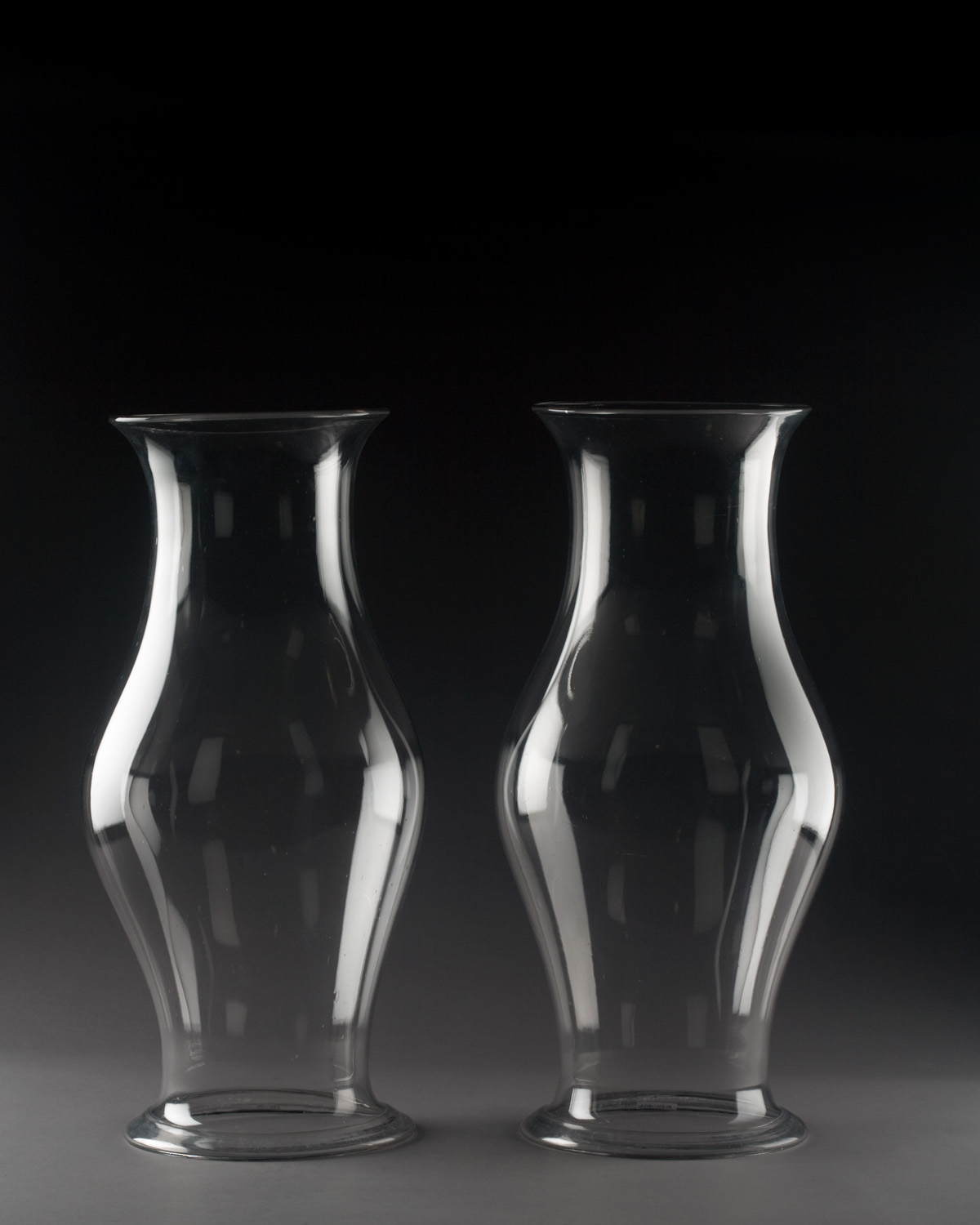 Appraisal: PAIR OF COLORLESS GLASS HURRICANE SHADES Each of bulbous form