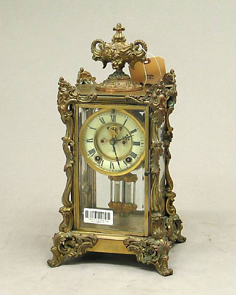 Appraisal: A Rococo style cast brass and four glass regulator clock