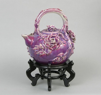 Appraisal: A Large Decorative Glazed Porcelain Teapot on Stand A large